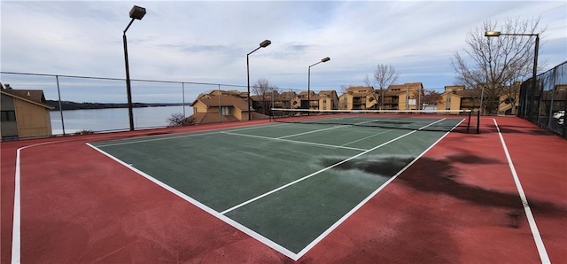 view of sport court featuring a water view and basketball court