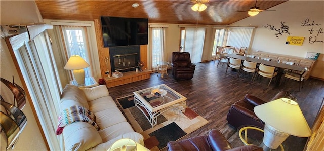 living room with vaulted ceiling, hardwood / wood-style floors, a fireplace, ceiling fan, and wooden ceiling