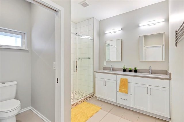 bathroom with toilet, a stall shower, visible vents, and a sink