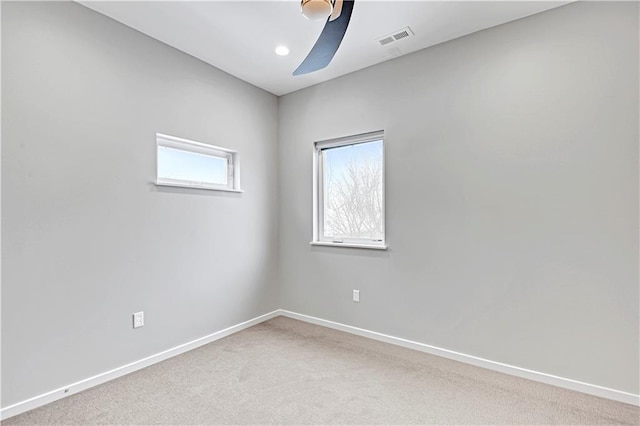 unfurnished room featuring ceiling fan, carpet flooring, visible vents, and baseboards