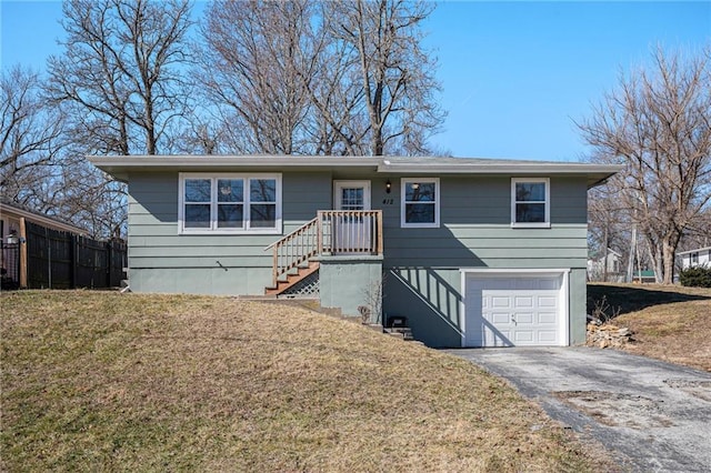 ranch-style home featuring a garage, driveway, and a front lawn