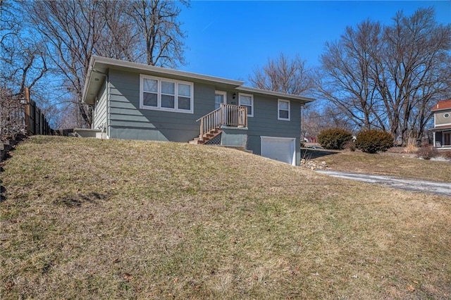 ranch-style home featuring an attached garage and a front lawn