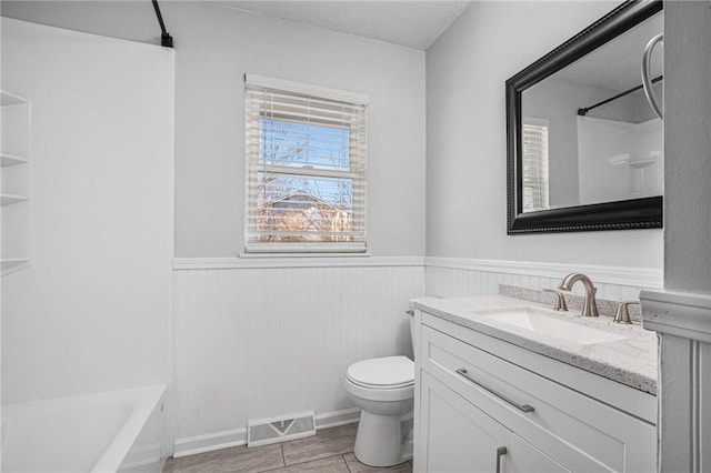 full bath with toilet, a wainscoted wall, wood finished floors, vanity, and visible vents