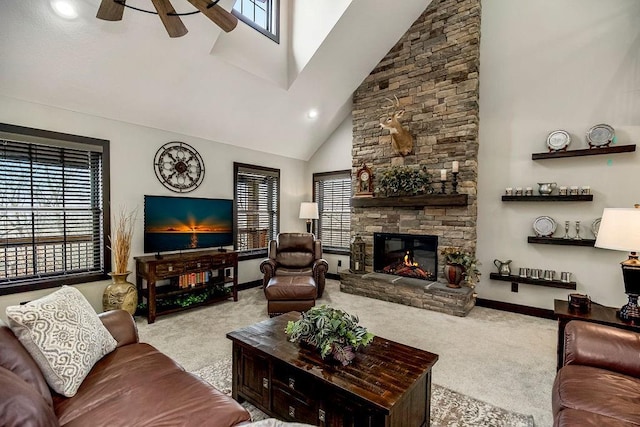 carpeted living room featuring a stone fireplace, high vaulted ceiling, and ceiling fan