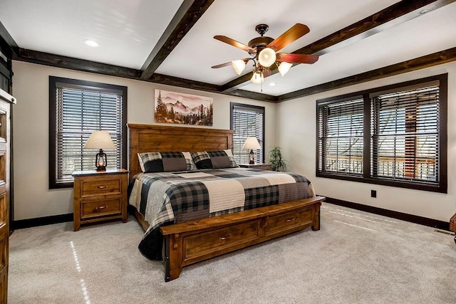 bedroom with ceiling fan, light carpet, and beam ceiling