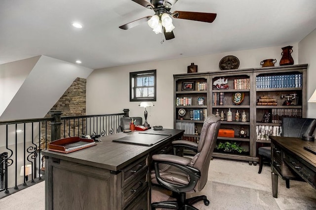 carpeted office space with ceiling fan