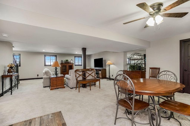 dining area with light carpet and ceiling fan