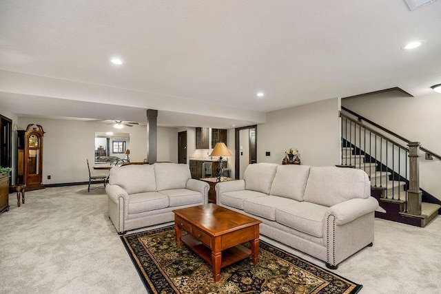 carpeted living room featuring ceiling fan