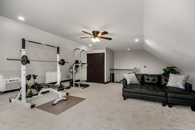 exercise room with lofted ceiling and light colored carpet