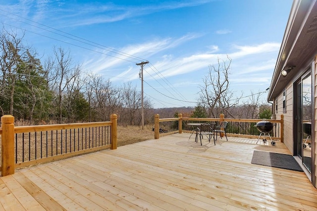 wooden deck with a grill