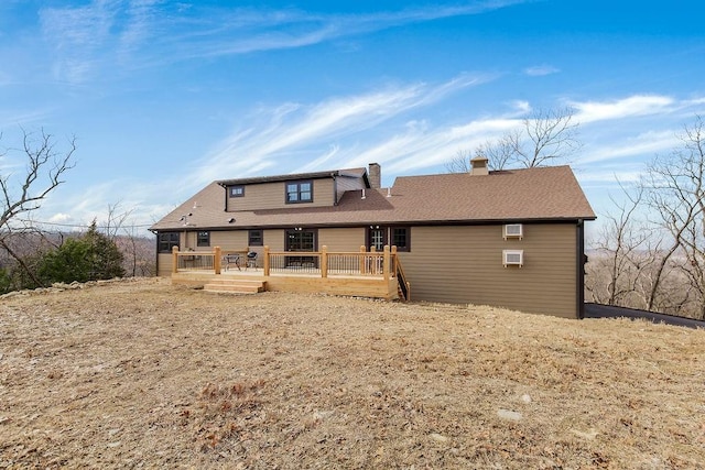 rear view of house featuring a deck