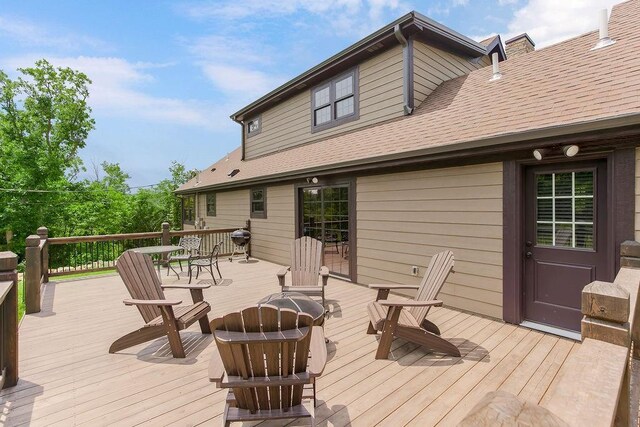 2909 S 74th St, Kansas City, KS 66106 - wooden terrace with an outdoor fire pit and a grill