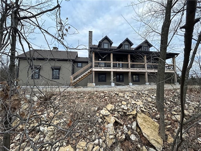2909 S 74th St, Kansas City, KS 66106 - rear view of property featuring stairs, a deck, and a chimney