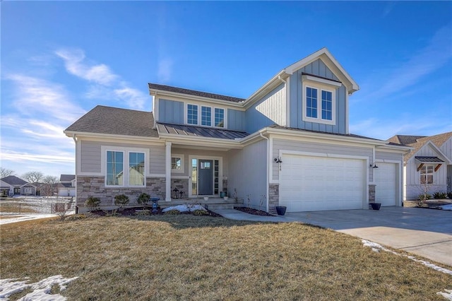 view of front of property with board and batten siding, concrete driveway, a front yard, a garage, and stone siding