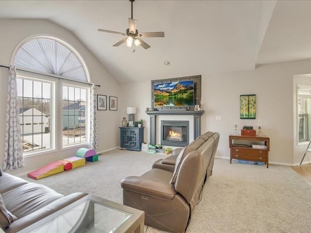 living room featuring ceiling fan, lofted ceiling, and light carpet