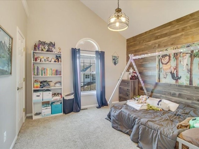 carpeted bedroom featuring wooden walls and vaulted ceiling