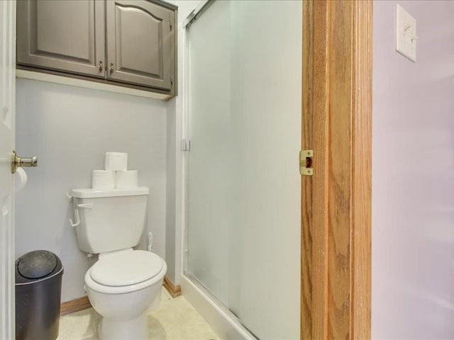 bathroom with toilet and an enclosed shower