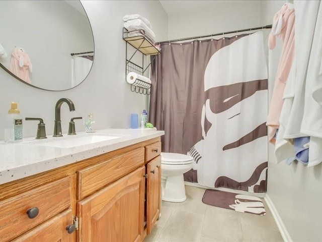 bathroom featuring tile patterned flooring, vanity, and toilet