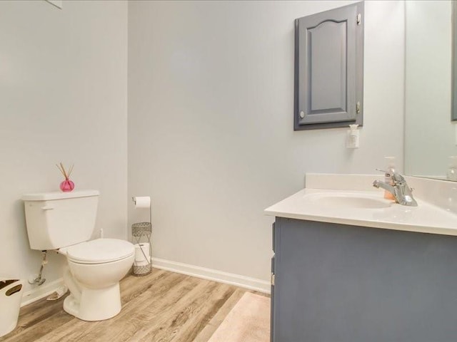 bathroom with vanity, hardwood / wood-style floors, and toilet