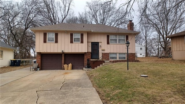 bi-level home with a garage and a front lawn