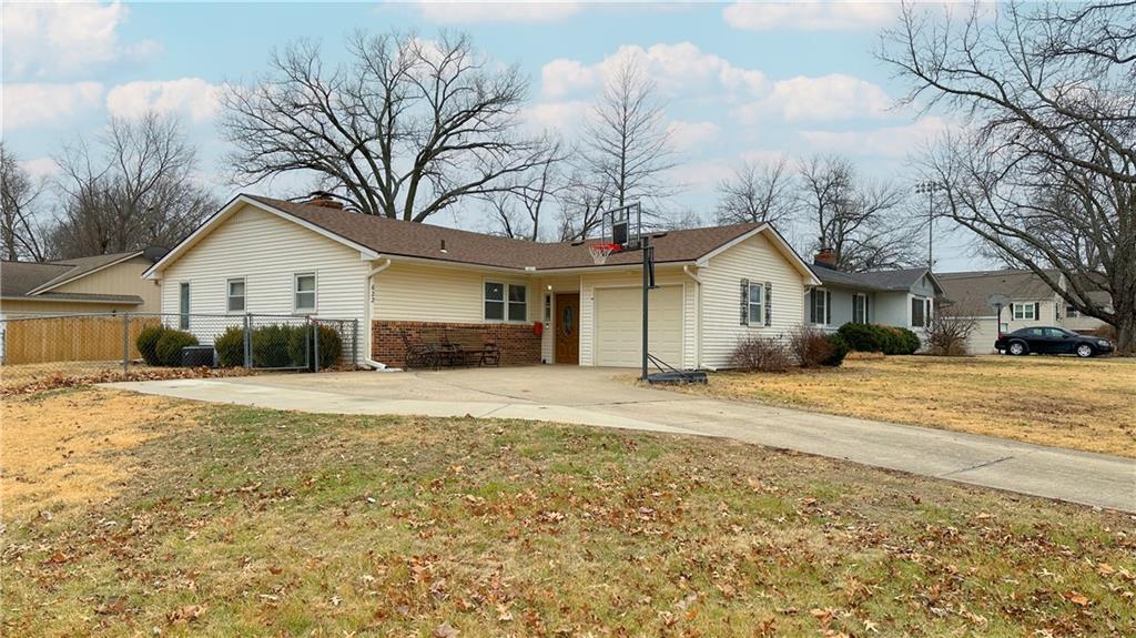 ranch-style home with a garage and a front yard