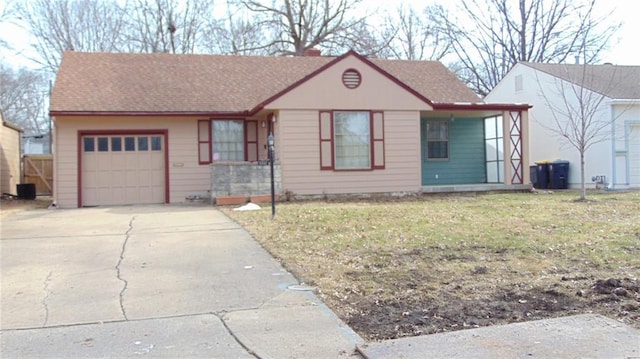 view of front of property featuring a garage and a front lawn