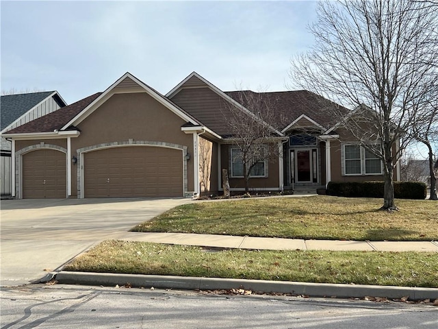 view of front of home with a garage and a front yard