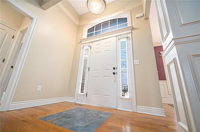 entryway with baseboards and wood finished floors