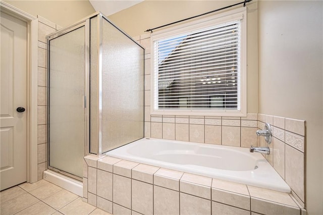 bathroom featuring a shower stall, a bath, and tile patterned floors