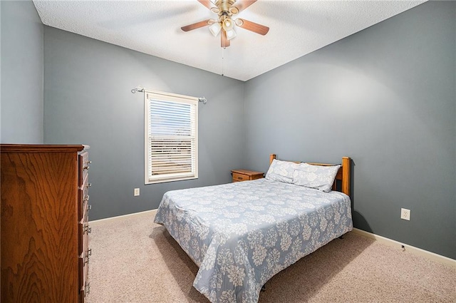 bedroom with carpet, baseboards, ceiling fan, and a textured ceiling