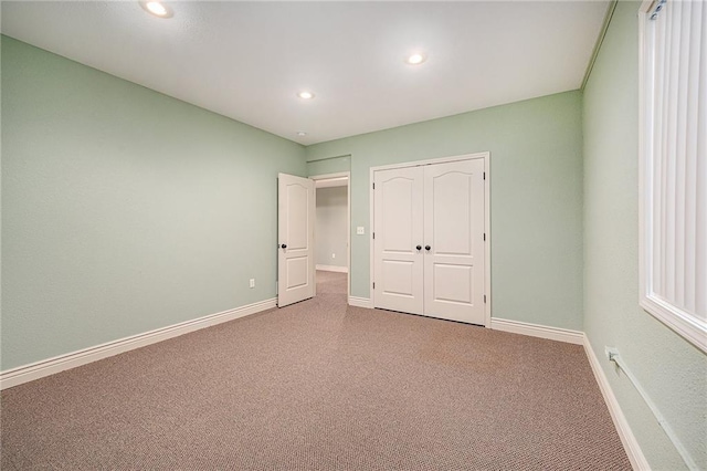 unfurnished bedroom with carpet and a closet