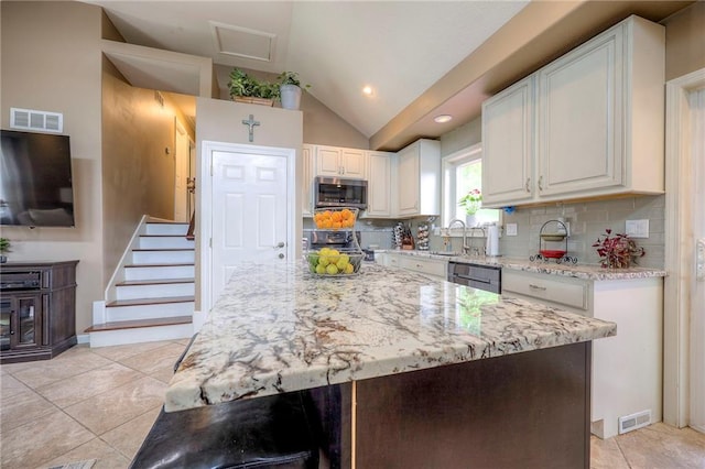 21465 W 180th St, Olathe, KS 66062 - kitchen with appliances with stainless steel finishes, vaulted ceiling, light stone countertops, white cabinetry, and tasteful backsplash