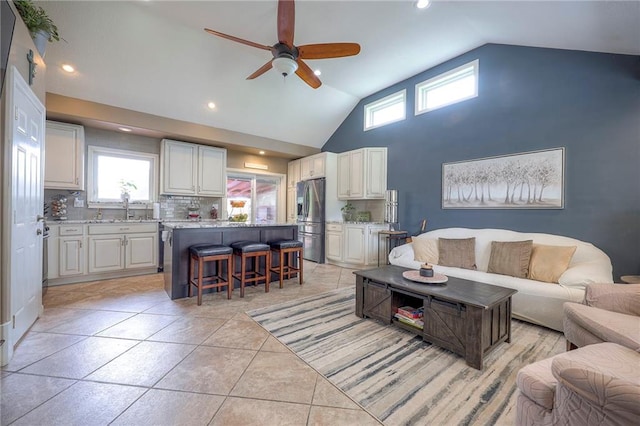 21465 W 180th St, Olathe, KS 66062 - living area with a ceiling fan, healthy amount of natural light, recessed lighting, light tile patterned floors, and high vaulted ceiling
