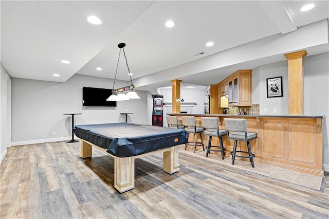 recreation room featuring decorative columns, indoor bar, billiards, and light hardwood / wood-style flooring