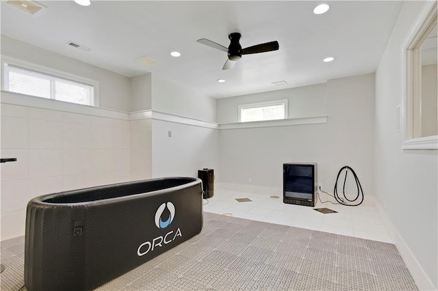 miscellaneous room featuring light tile patterned floors and ceiling fan