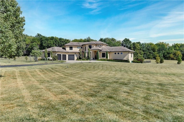 view of front of property featuring a garage and a front lawn