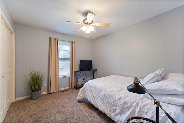 carpeted bedroom with ceiling fan and a closet