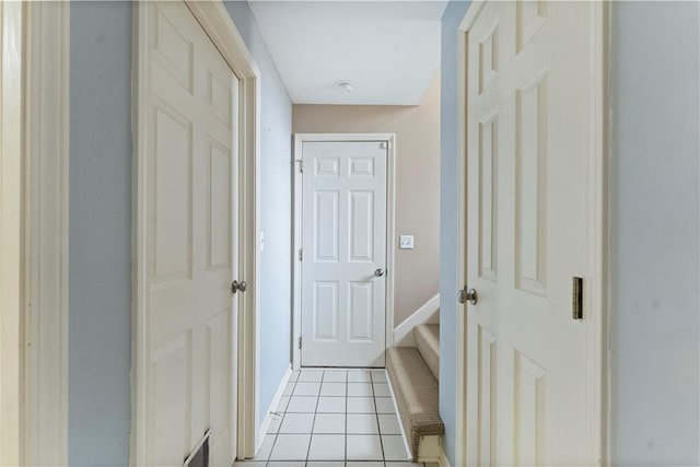 hall featuring light tile patterned floors