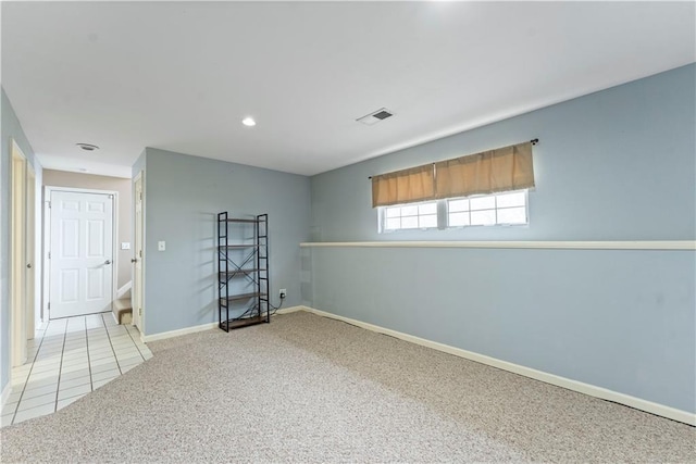 unfurnished room featuring light carpet