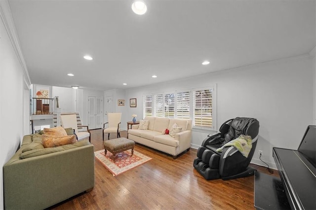 living room featuring hardwood / wood-style flooring and crown molding