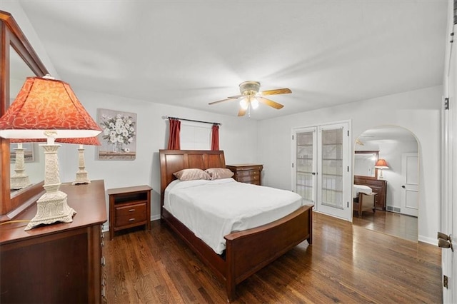 bedroom with dark hardwood / wood-style flooring, french doors, and ceiling fan