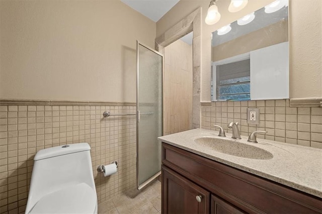 bathroom with walk in shower, vanity, toilet, and tile walls