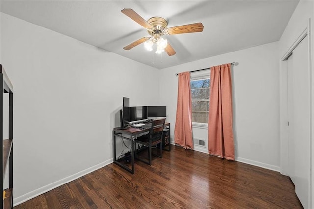 office with dark wood-type flooring and ceiling fan