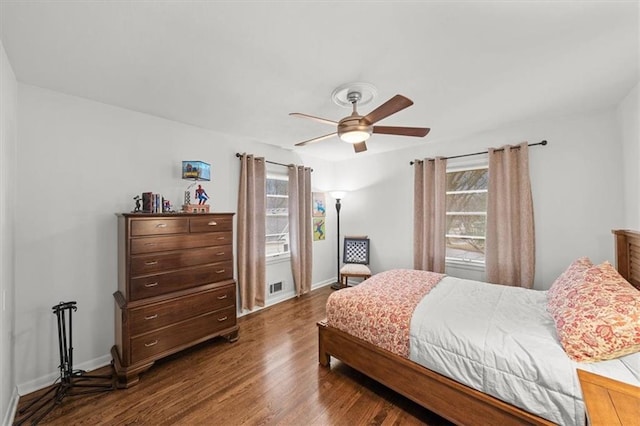 bedroom with dark hardwood / wood-style flooring and ceiling fan