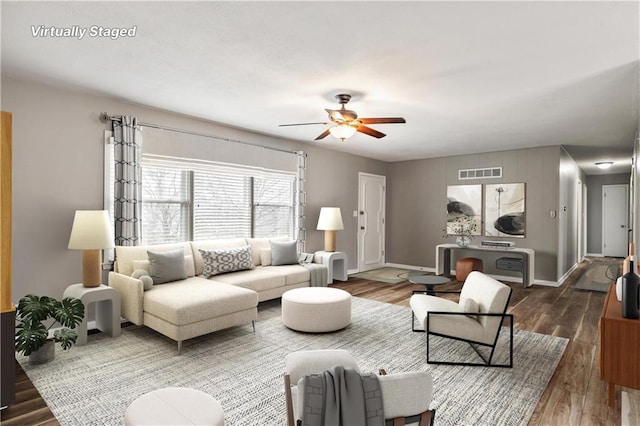 living room featuring ceiling fan and dark hardwood / wood-style flooring