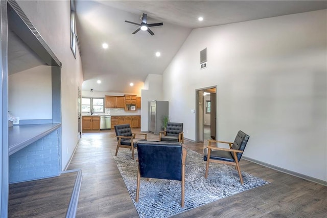 living room featuring hardwood / wood-style flooring, high vaulted ceiling, sink, and ceiling fan