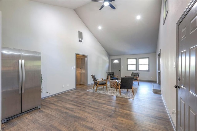 dining space with dark wood-type flooring, ceiling fan, and high vaulted ceiling