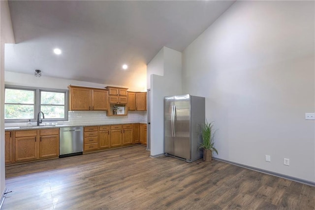 kitchen with sink, high vaulted ceiling, dark hardwood / wood-style flooring, stainless steel appliances, and decorative backsplash