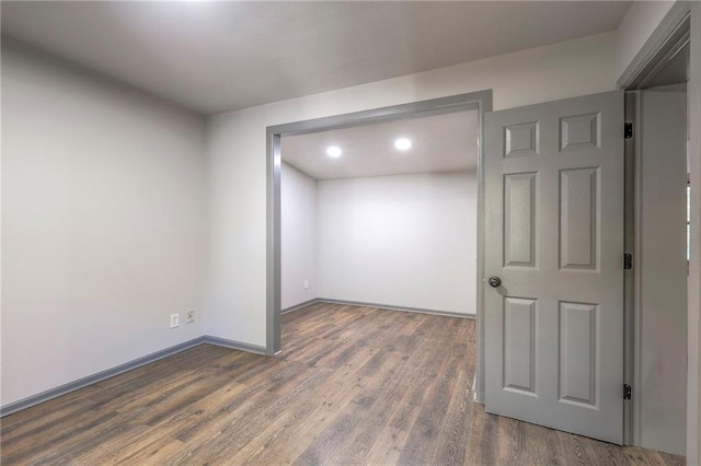 empty room with dark wood-type flooring