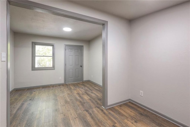 spare room with dark hardwood / wood-style flooring